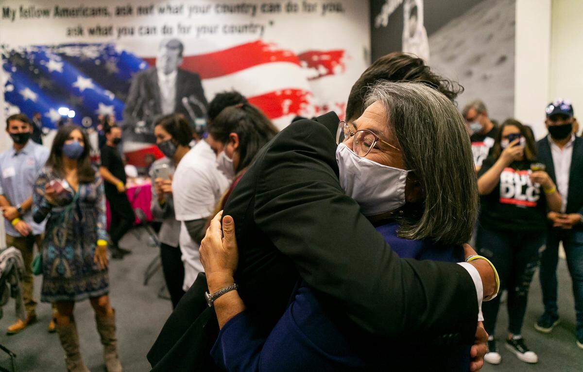 Miami-Dade mayoral candidate Daniella Levine Cava hugs supporters as she awaits the results of her election at a watch party in Wynwood, Florida on Tuesday, November 3, 2020.