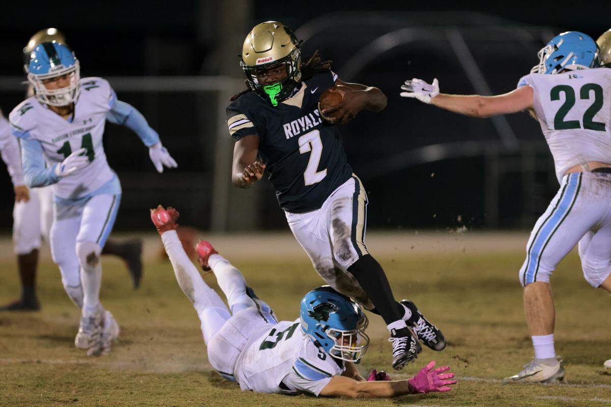 Immaculata-La Salle running back Adrian Cox (2) carries the football for a touchdown against Ransom Everglades during the first quarter of a Region 4-2A semifinal playoff game at Immaculata-La Salle High School on Friday, Nov. 21, in Miami, Fla.