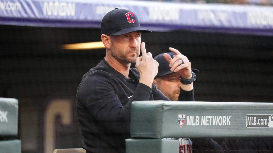 Cleveland Guardians bench coach Craig Albernaz (55) calls in a play in the first inning against the Colorado Rockies at Coors Field.