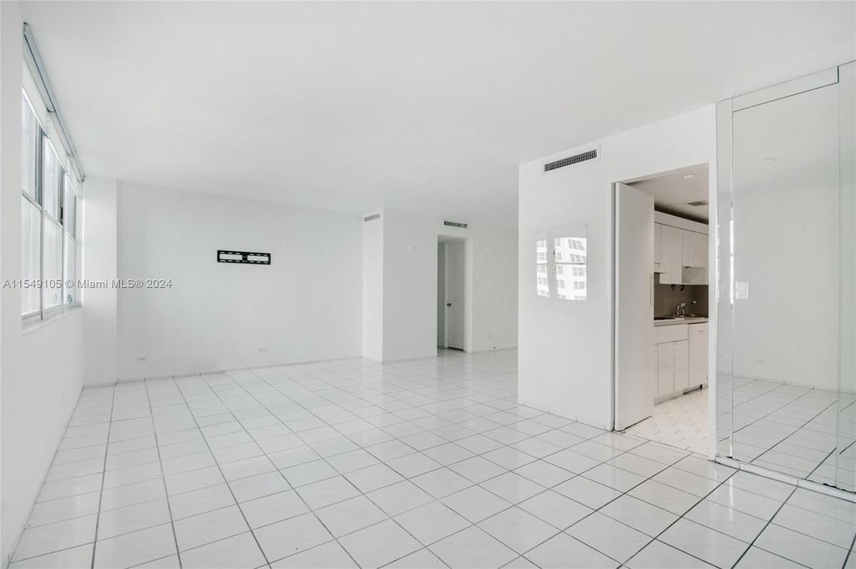The Mid-Beach apartment has an open floor plan with a living room and dining space.