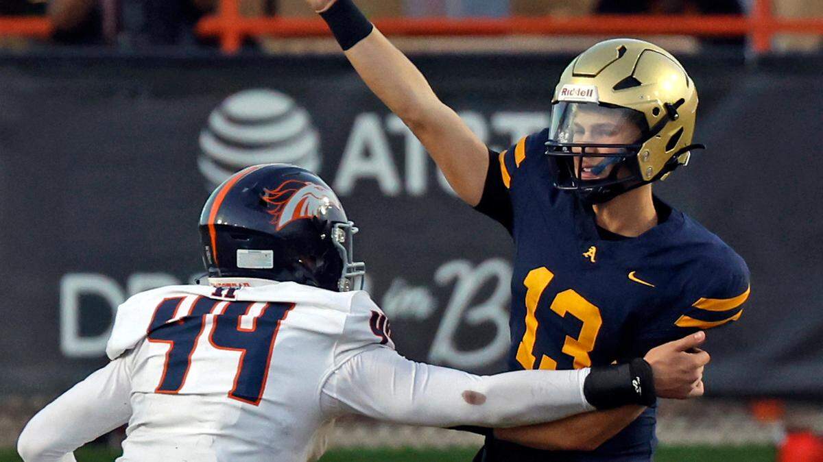 St. Thomas Aquinas quarterback Andrew Indorf (13) passes the ball as Homestead Broncos Johannes Mager (44) defends in the second half of the Class 3M state championships at Bragg Memorial Stadium in Tallahassee, Florida on Saturday, December 9, 2023.