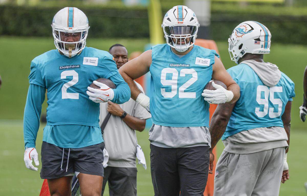 Miami Dolphins linebacker Bradley Chubb (2) and defensive tackle Zach Sieler (92) prepare for practice drills at the Miami Dolphins Training Camp in Miami Gardens, Florida, on Tuesday, August 26, 2025.