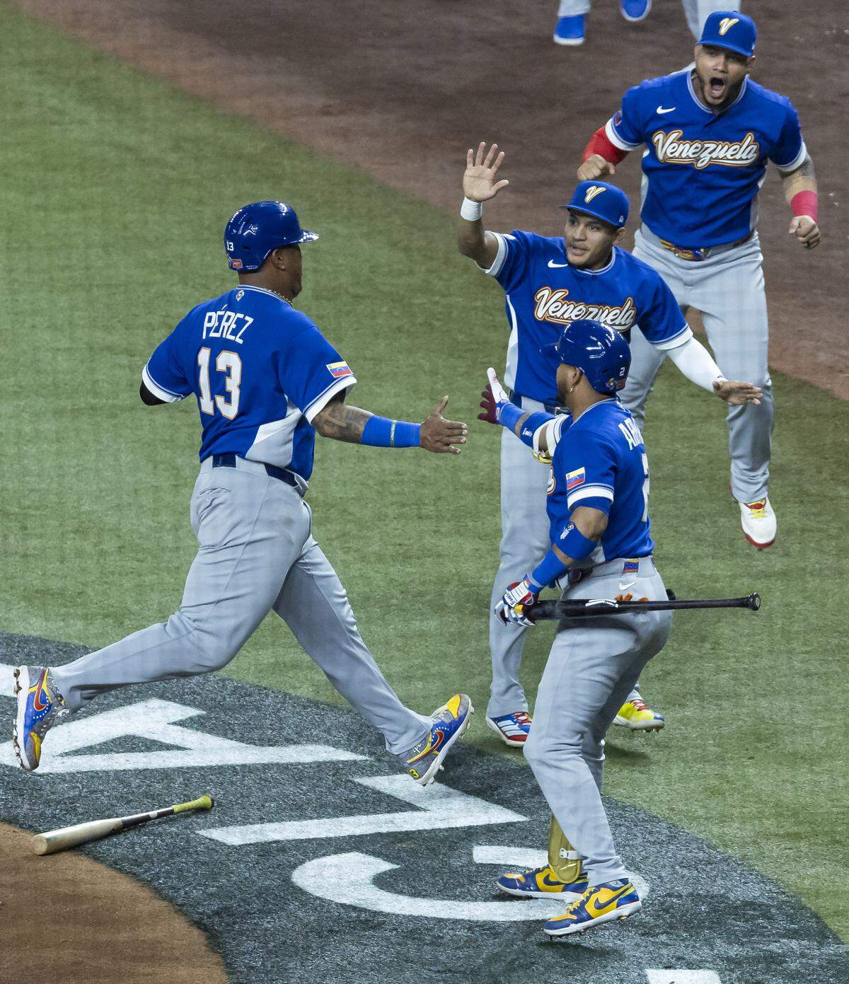 Venezuela catcher Salvador Perez (13) celebrates with his teammates after scoring a run against the United States in the third inning of their World Baseball Classic final game at loanDepot Park on Tuesday, March 17, 2026, in Miami, Fla.