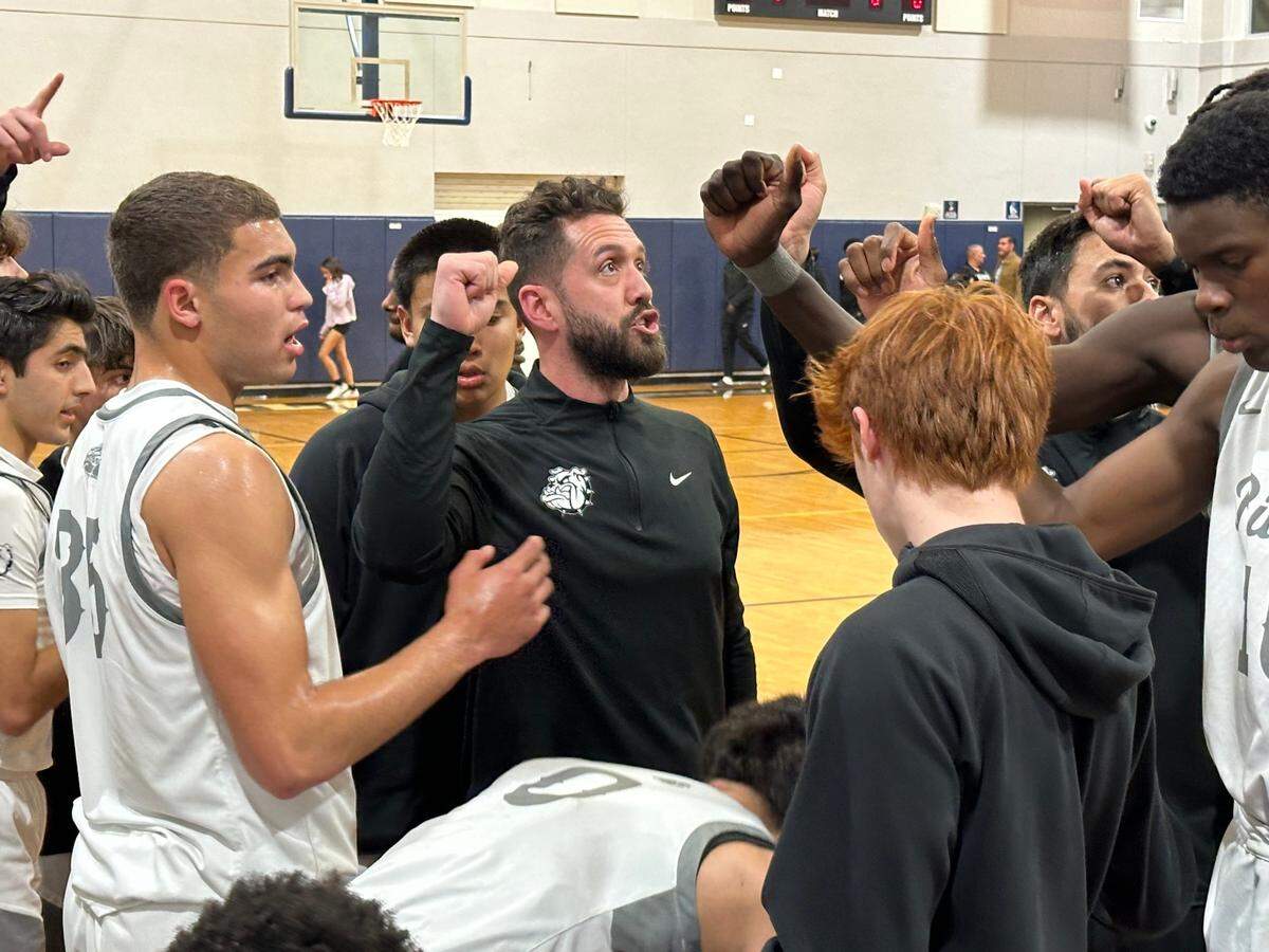 Riviera Prep boys’ basketball coach Anthony Shahbaz breaks the huddle with his team during a timeout in Tuesday night’s Region 4-3A semifinal at Riviera Prep.