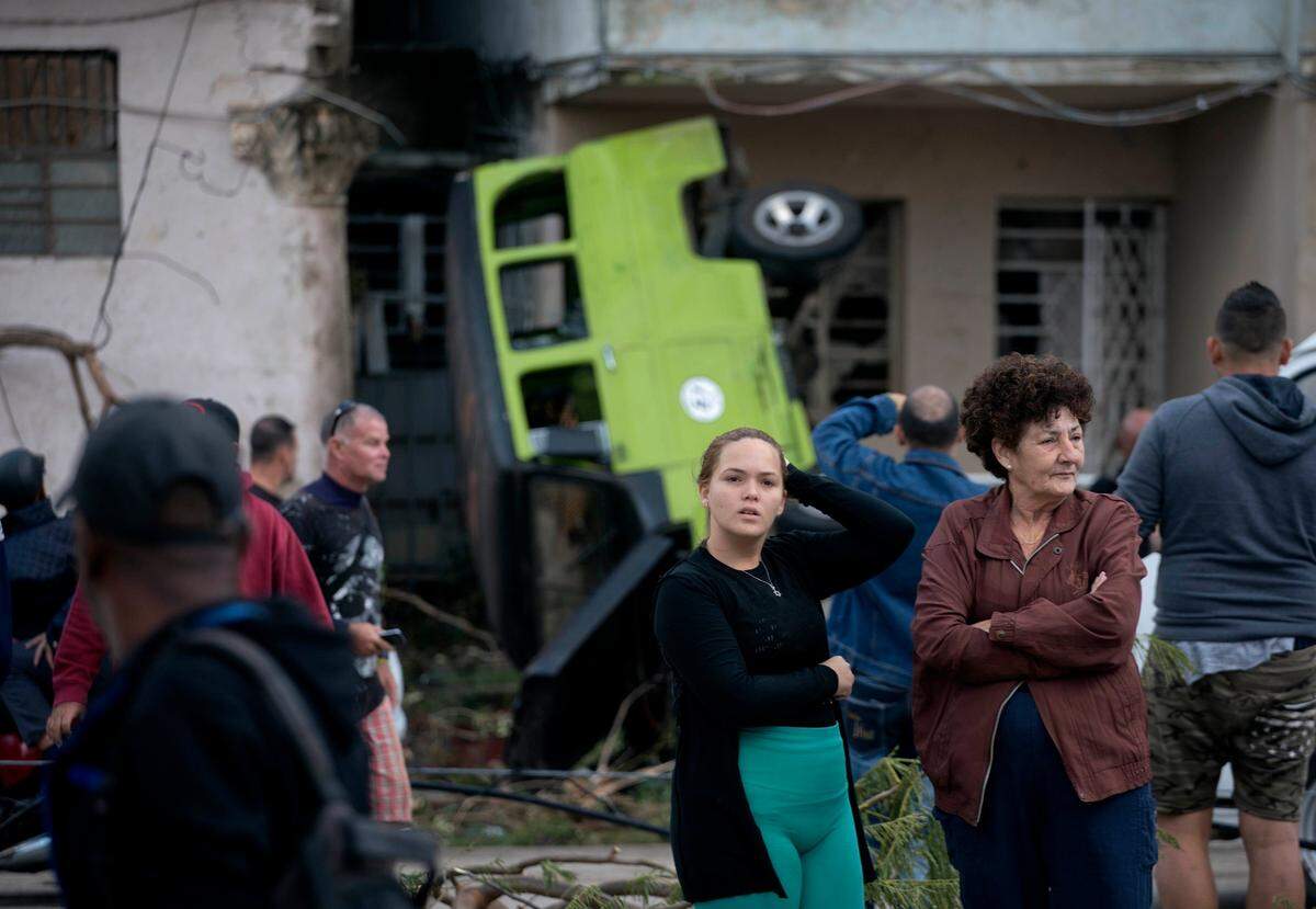 People survey the destruction left behind by a tornado in Havana, Cuba.