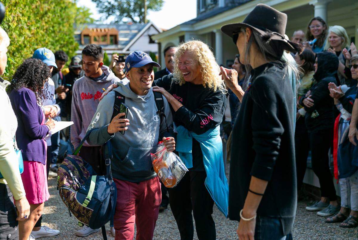 A Venezuelan migrant reacts as he is led onto a bus at St. Andrews Episcopal Church on Friday, Sept. 16, 2022, in Edgartown, Mass on the island of Martha’s Vineyard. A group of 48 migrants was flown to the island from Texas earlier this week.