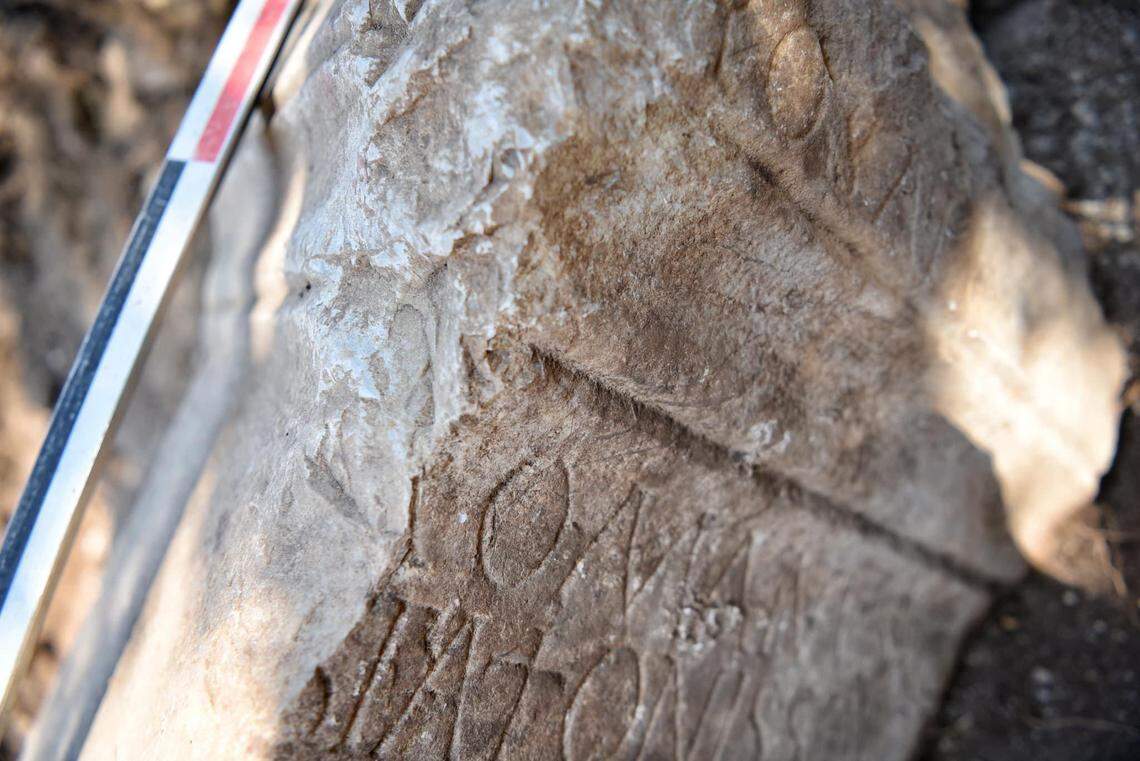 The stone is a spolia, or a piece that was taken from one building in order to build another.