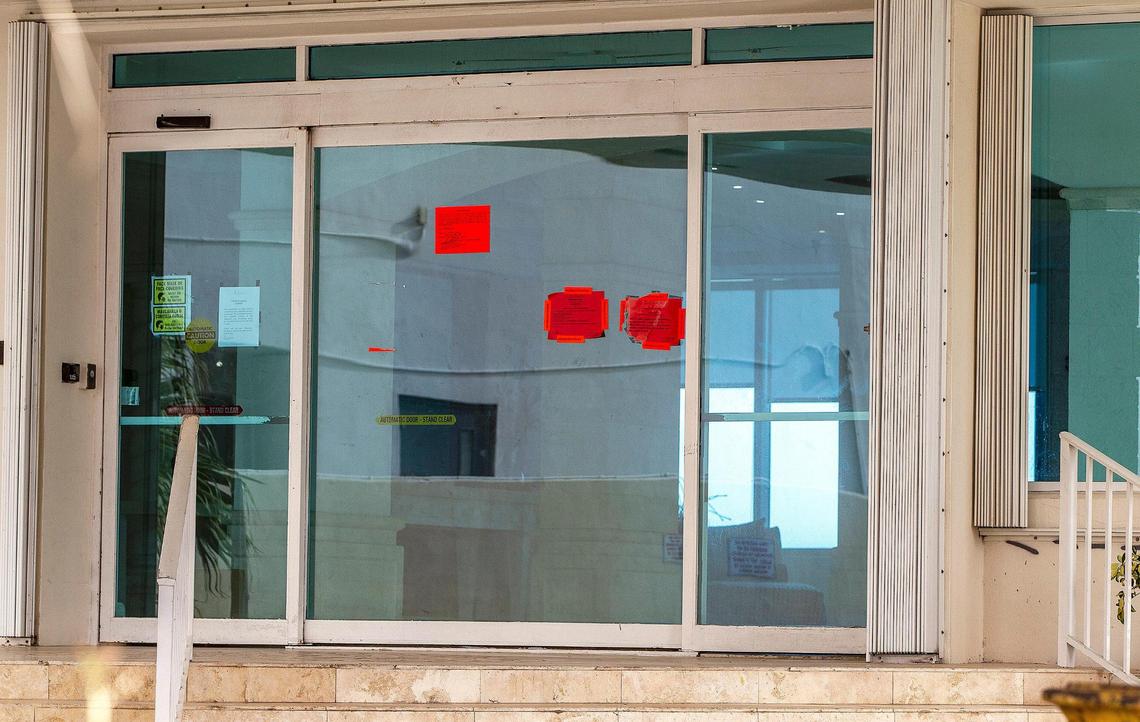 Red hazard notices posted by the city of Miami Beach dot the entrance of the La Costa condominium, 5333 Collins Ave. The city ordered the tower vacated because of structural and other problems.