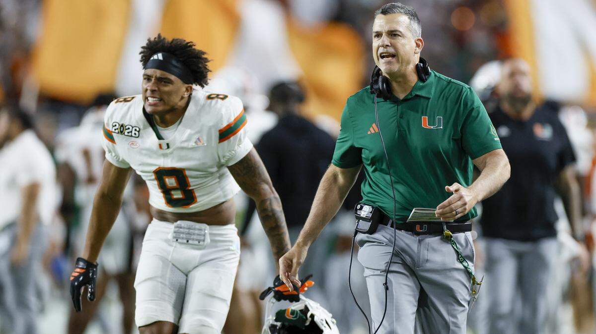 Miami Hurricanes head coach Mario Cristobal and Miami Hurricanes defensive back Jakobe Thomas (8) react after running back Mark Fletcher Jr. (4) scores in the second half against the Indiana Hoosiers in the College Football Playoff National Championship Game at Hard Rock Stadium in Miami Gardens, Florida, on Monday, January 19, 2026.