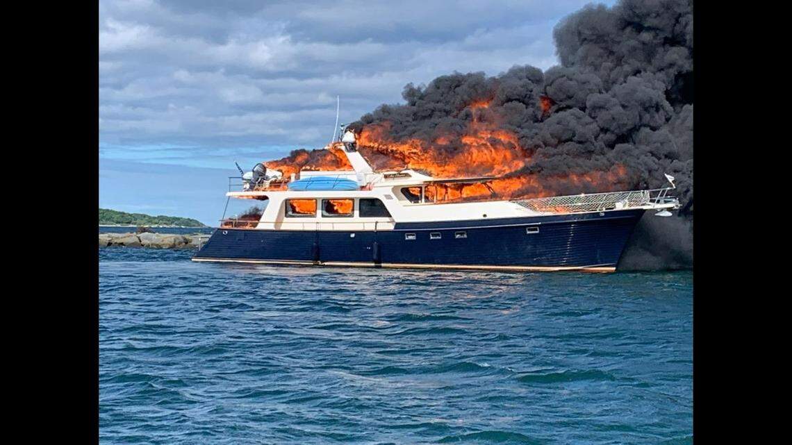 Passengers on a yacht jumped overboard as the boat caught fire and burned in New Hampshire, officials said.