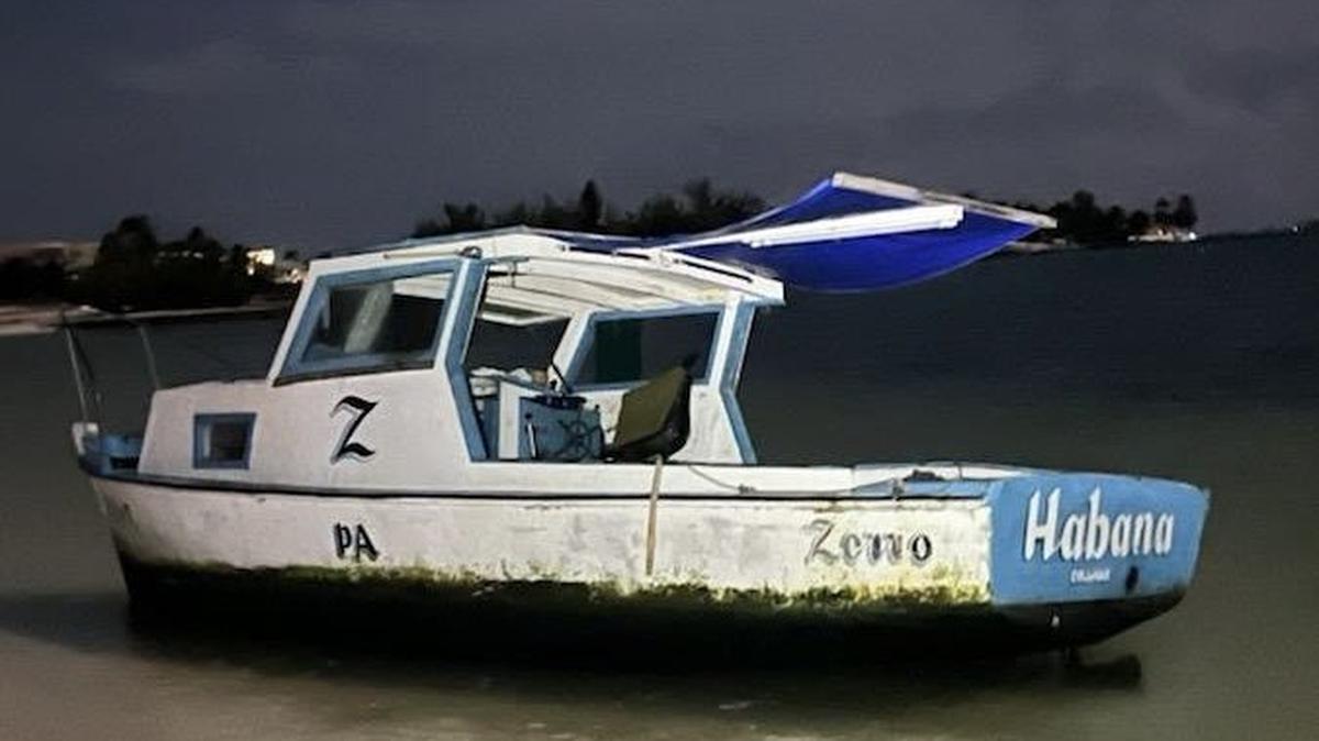 A wooden fishing boat rests on Sombrero Beach in the Florida Keys Tuesday, Sept. 17, 2024. The U.S. Border Patrol says 43 people from Cuba, who the agency says are migrants, arrived on the vessel.