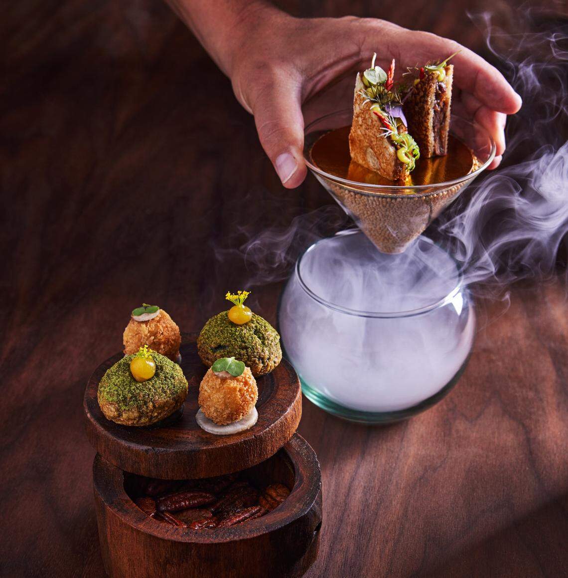 The amuse bouche at Tambourine Room include one cheesy bite, one potato-based bite and a sublime bit of oxtail served over smoke.