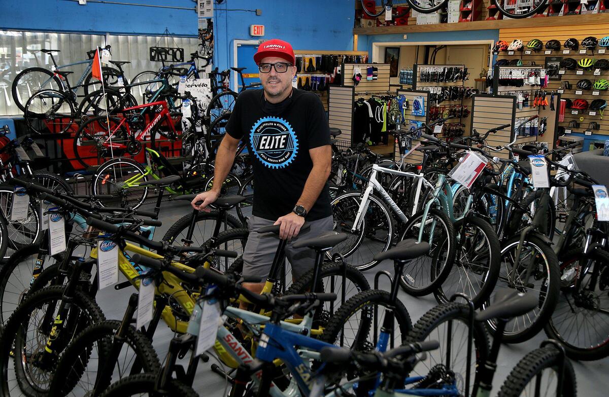 Elite Cycling owner Marcelo Penengo stands in his shop, closed by the coronavirus pandemic. Though customers are not allowed in, the shop is selling and assembling bikes for curbside pickup amid a spike in demand for some types of bicycles during quarantine.
