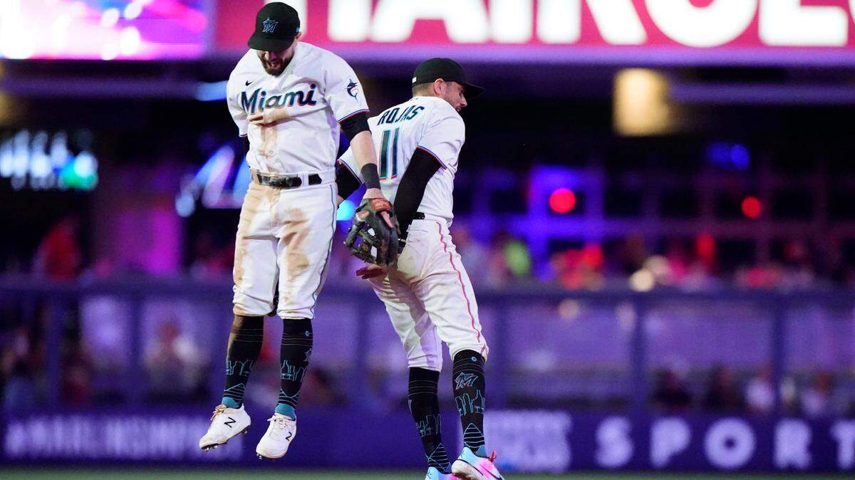 Miami Marlins second baseman Jon Berti, left, and shortstop Miguel Rojas (11) celebrate after the Marlins beat the Atlanta Braves 4-0 in a baseball game, Monday, Oct. 3, 2022, in Miami. (AP Photo/Wilfredo Lee)