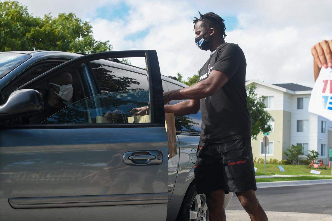 Miami Marlins outfielder Lewis Brinson gives out free meals at the Liberty Square Community Center polling station in Liberty City on Tuesday, Nov. 3, 2020.