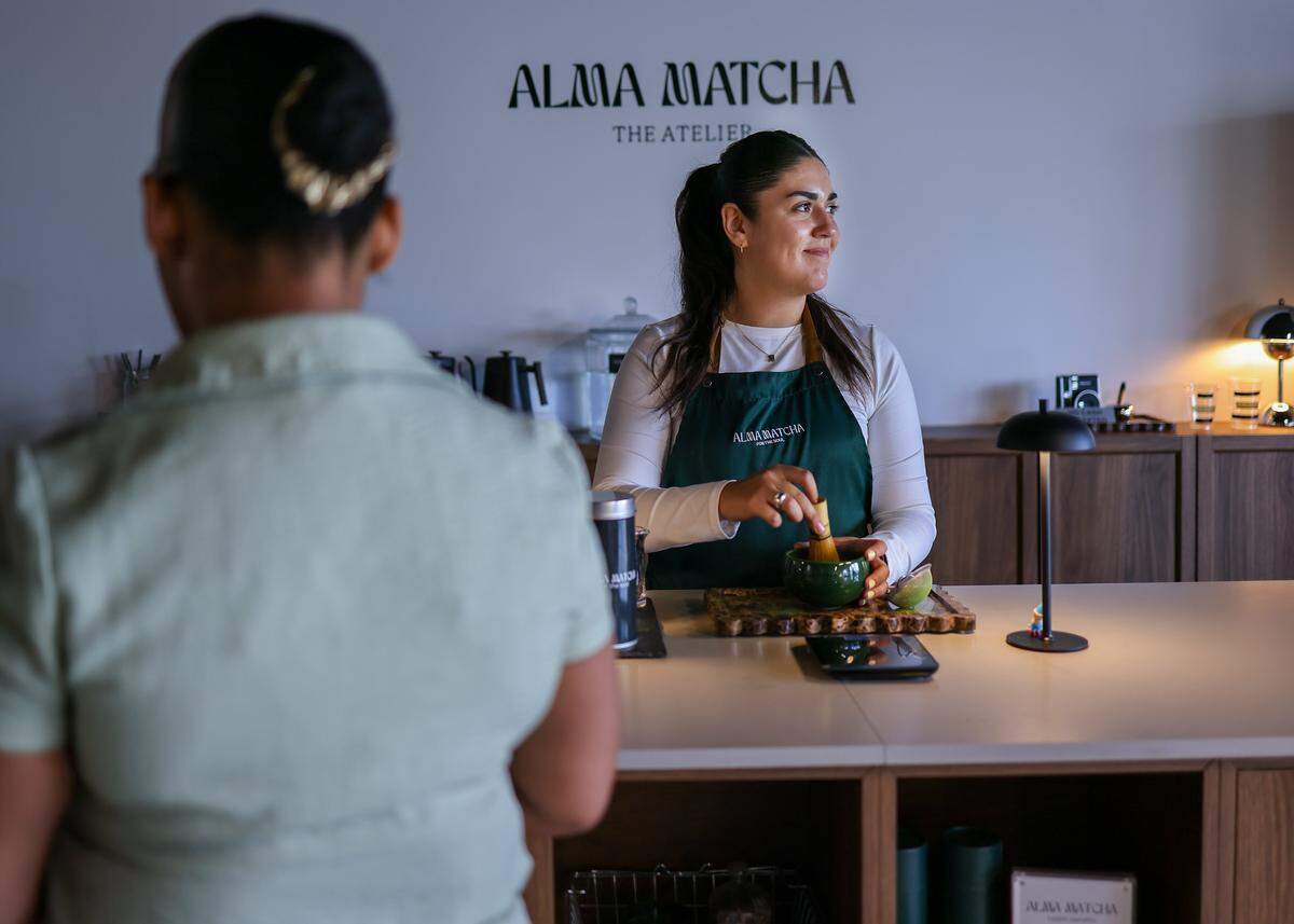 Maddison Haruch, right, prepares a matcha for a customer at Alma Matcha's temporary location as the buildout for its permanent store is underway at the Thrive Art District. The THRIVE Art District, an arts and commercial hub in Fort Lauderdale that caters to young professionals, is now open. The Miami Herald toured the new art district and local businesses on Wednesday, March 18, 2026, in Fort Lauderdale, Florida.