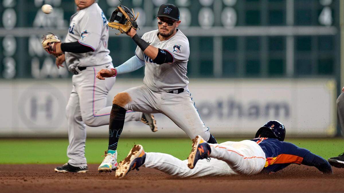 Houston Astros’ Jeremy Pena, right, steals second base as Miami Marlins shortstop Miguel Rojas reaches for the throw from catcher Nick Fortes during the fifth inning of a baseball game Sunday, June 12, 2022, in Houston. (AP Photo/David J. Phillip)