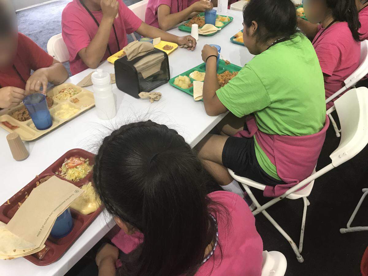 An image released late Wednesday shows children eating at a table in the Homestead detention center. HHS said the photo was taken earlier Wednesday.