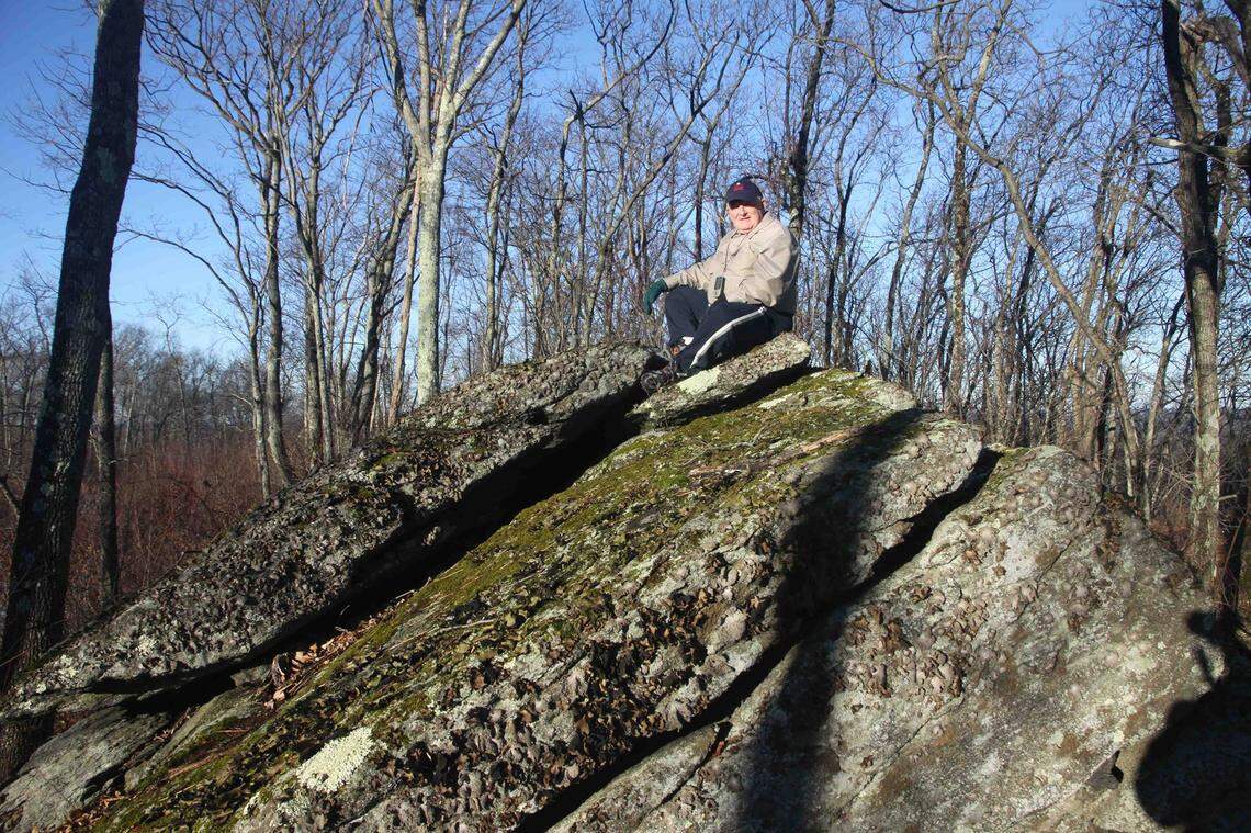 “Spooky” Mike Schwartz sits atop a boulder on Burley Hill, near the high point of Tolland County, Connecticut, in 2014.