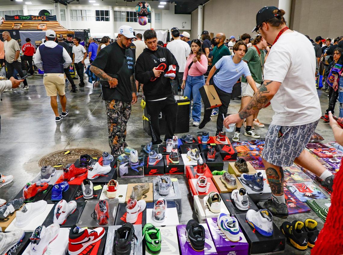 Attendees compare sneakers during SneakerCon at the Broward County Convention Center in Fort Lauderdale, Florida, on Saturday, Jan. 11, 2025.