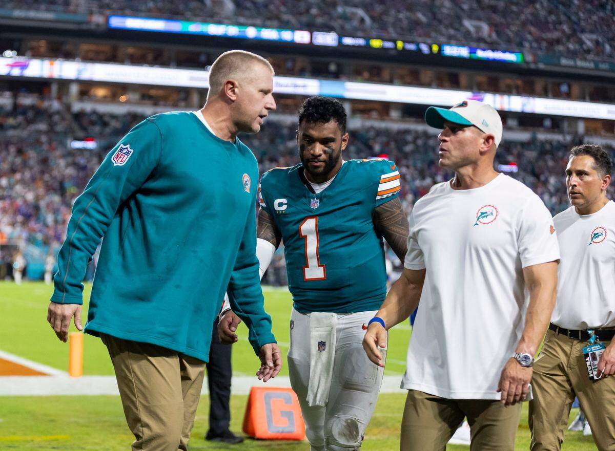 Miami Dolphins quarterback Tua Tagovailoa (1) walks off the field after suffering a concussion in a play against the Buffalo Bills in the second half of their NFL game at Hard Rock Stadium on Thursday, Sept. 12, 2024, in Miami Gardens, Fla.