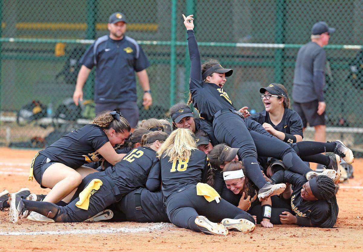 American Heritage HS Kelly Torres sits on top of the pile as they celebrate after defeating Land O’Lakes HS in the Class 6A Division Finals of the FHSSA Softball State Championships in Vero Beach, Florida, May 24, 2018.