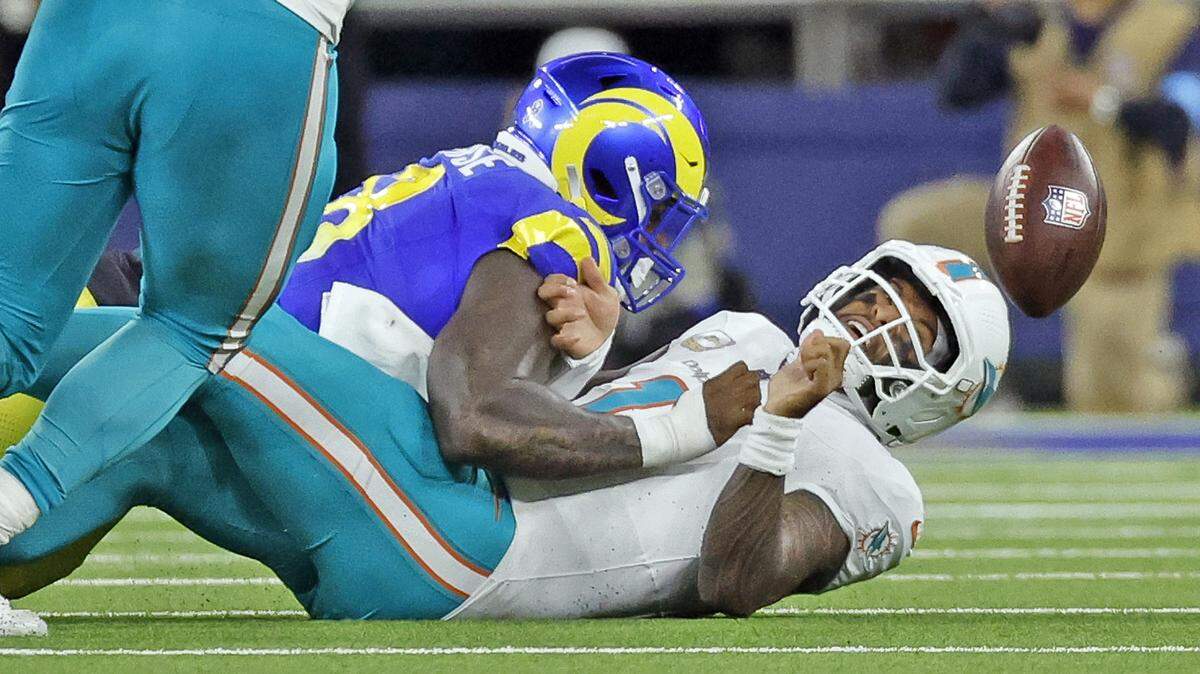 Miami Dolphins quarterback Tua Tagovailoa (1) fumbles the ball in the first half against the Los Angeles Rams during their NFL football game at SoFi Stadium in Inglewood, California on Monday, November 11, 2024.