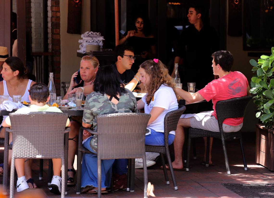 Patrons enjoy lunch at the Greenstreet Cafe in Coconut Grove on Thursday, August 3, 2019. The Grove is in the midst of redevelopment with the construction of office buildings, new restaurants, and other development projects.