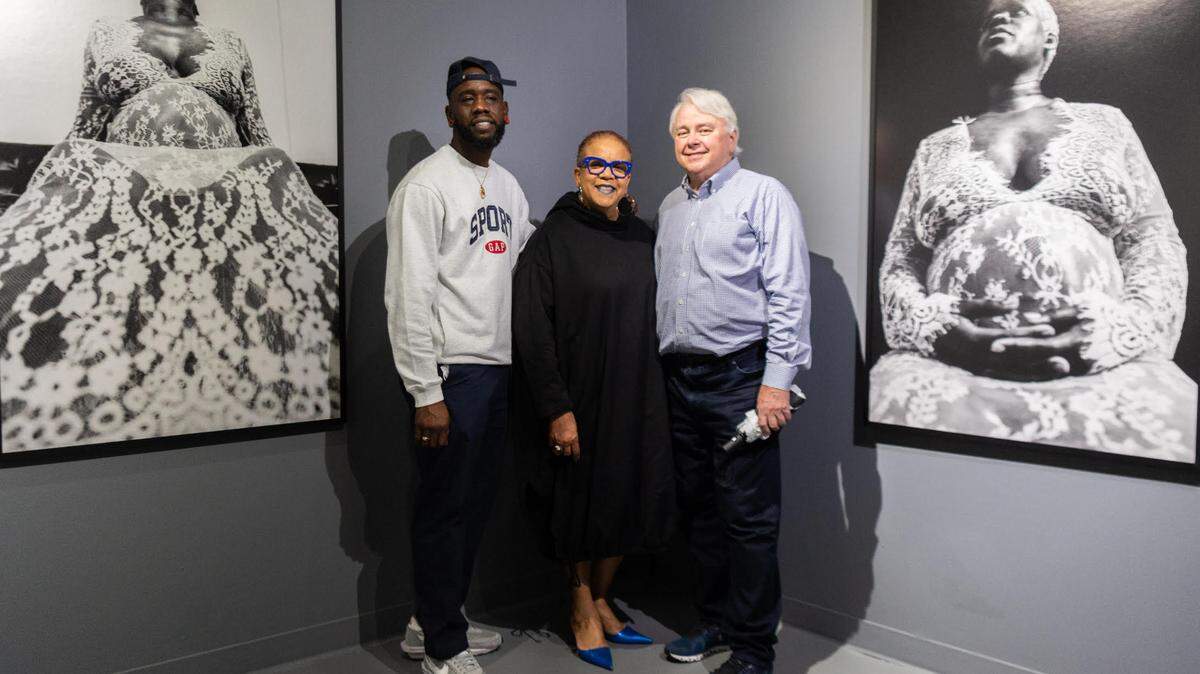Roscoè B. Thické III, curator Rosie Gordon-Wallace, and Dennis Scholl president and CEO of Oolite Arts in front of “Absolute,” which expresses the power and beauty of Thické’s pregnant friend in a stylized photo shoot.