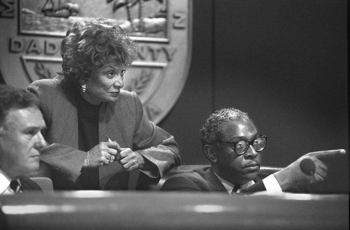 Maurice Ferre, left, and Arthur Teele, right, during a 1994 Miami-Dade County Commission meeting, with Gwen Margolis at center.