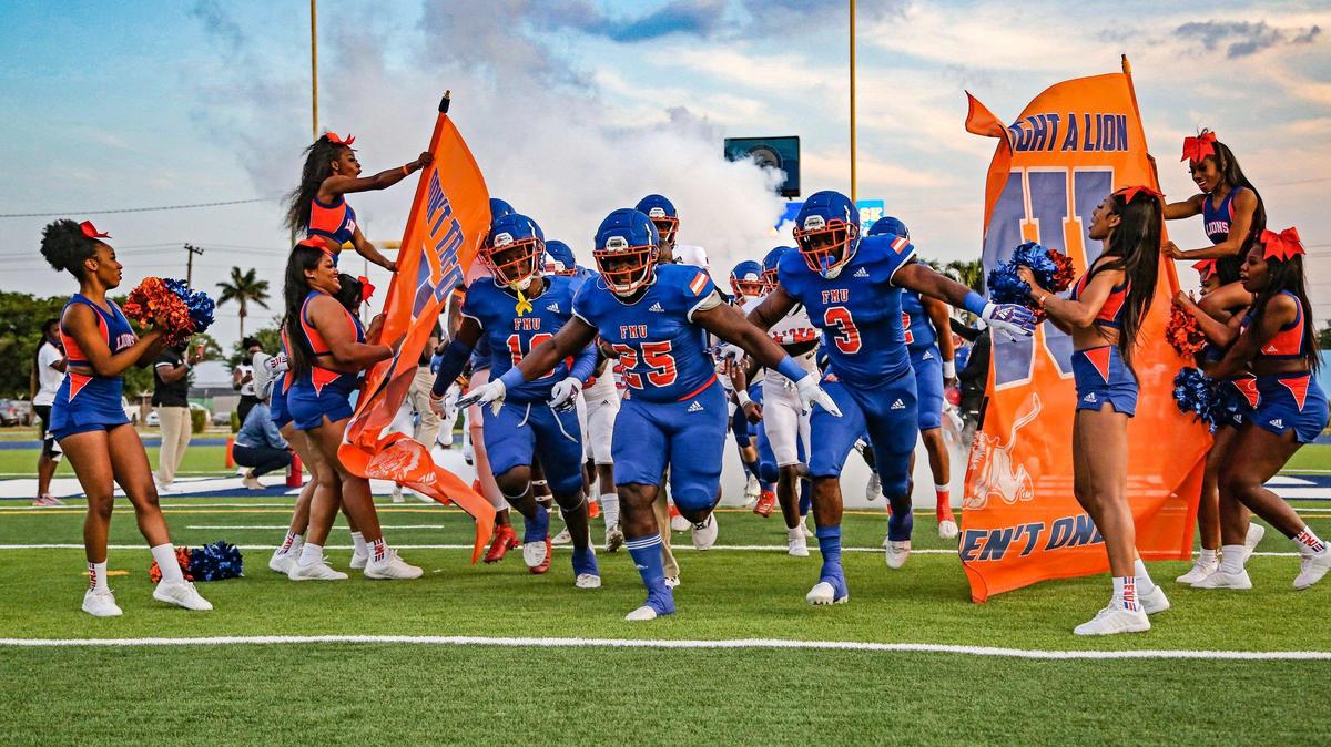 Florida Memorial University’s football team rushes the field for the start of the offense and defense scrimmage at Traz Powell Stadium in Miami on Friday, April 16, 2021.