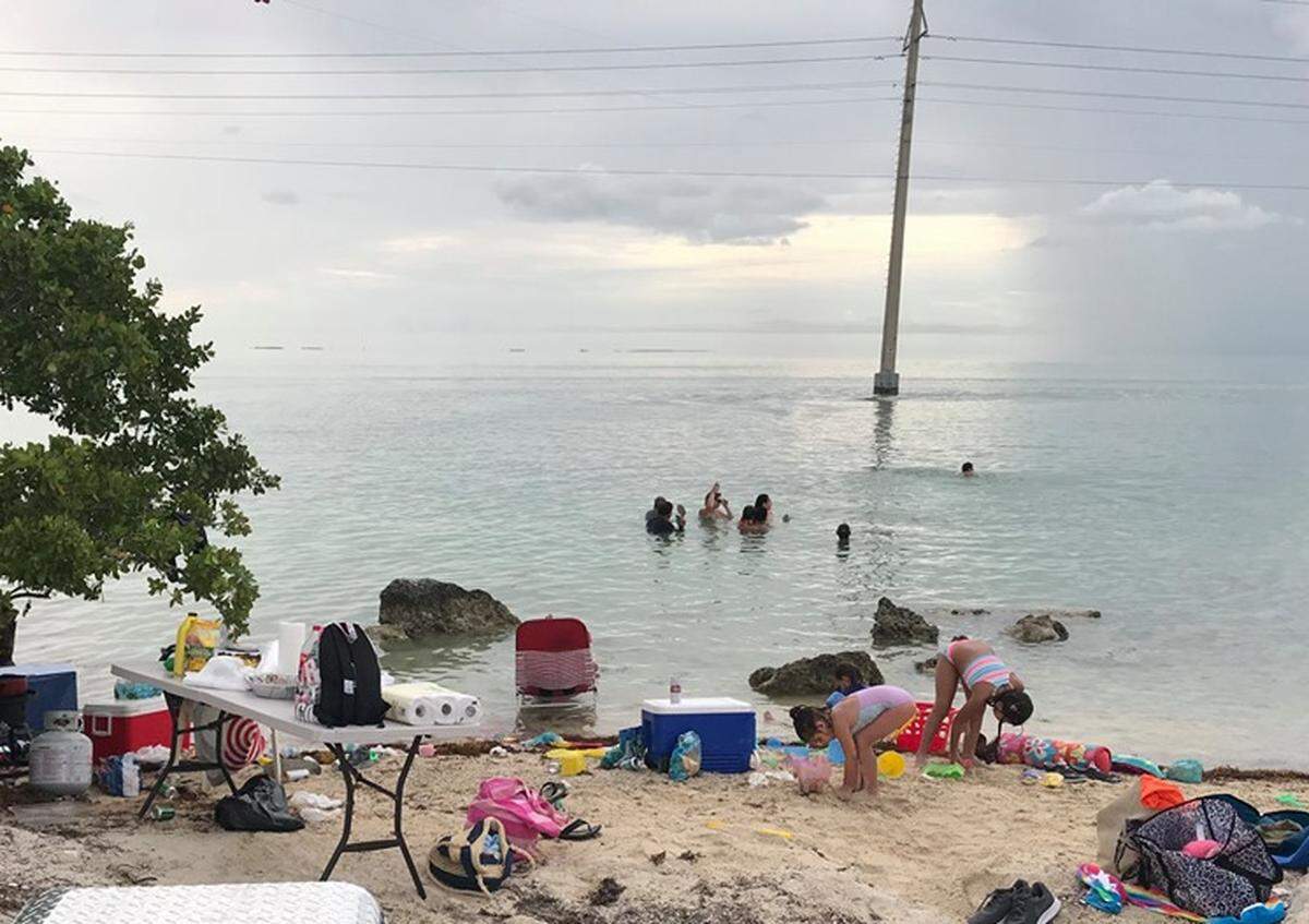 Families gather on the beach at Indian Key fill in Islamorada recently. Islamorada residents and officials want the state, which owns the land, to do more to limit the amount of people who gather there, citing litter and traffic congestion issues.