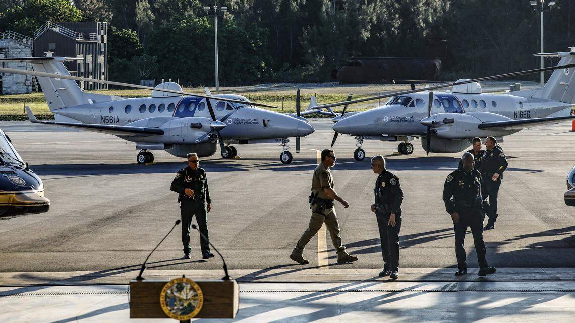 U.S. law enforcement officials await the arrival of Florida Governor Ron DeSantis for a press conference at the Homestead Air Force Base alongside Department of Homeland Security Senior Counselor Keith Pearson in Homestead, Florida on Wednesday, February 26, 2025.