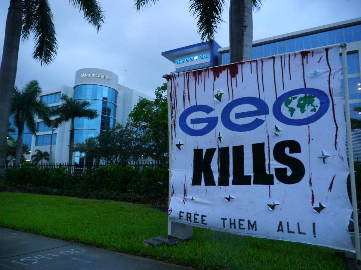 An unnamed activist collective placed 14 body bags with toe tags and a sign reading “GEO Kills Free Them All” on the grounds of the GEO Group in Boca Raton, Florida, on May 15, 2020. The bags named people who died at immigration detention centers in South Florida.