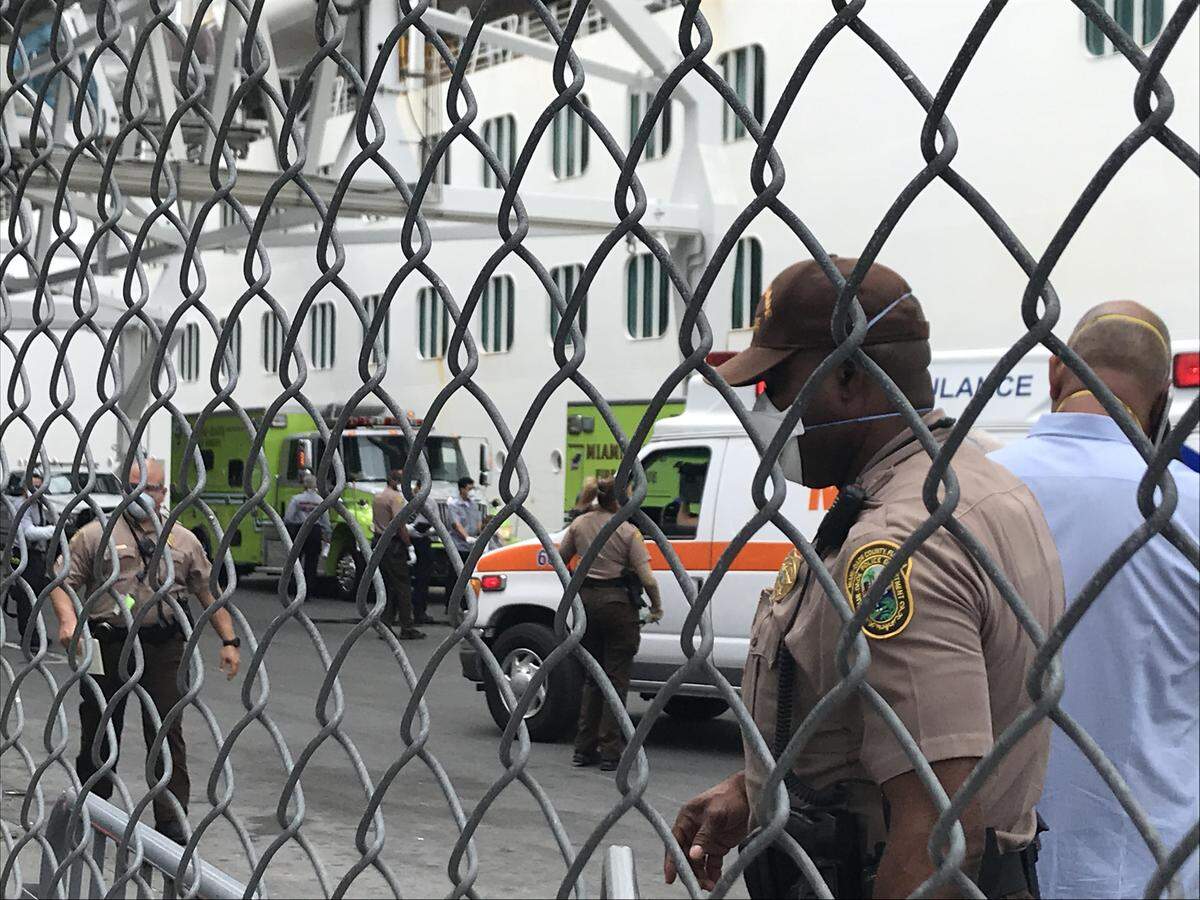 Miami-Dade Fire Rescue waits outside the Coral Princess crusie ship, where several passengers have become critically ill and need transportation to the hospital.