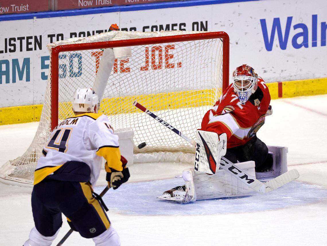 Florida Panthers goalie Sergei Bobrovsky (72) blocks a shot as he defends the goal from Nashville Predators defenseman Mattias Ekholm (14) during the second period of their NHL game at the BB&T Center on Thursday, March 18, 2021 in Sunrise, Fl.
