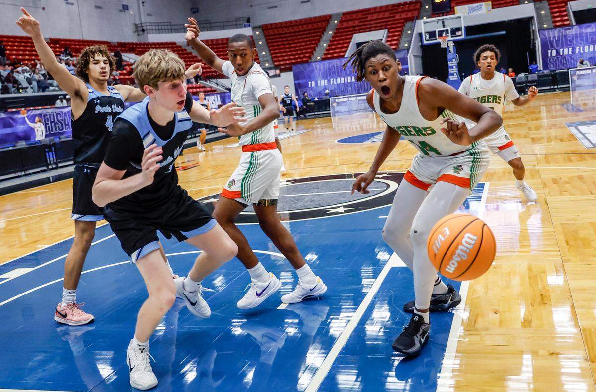 Blanche Ely Tigers’ Kaleb Corbitt (14) and Ponte Vedra High School’s Trace Westercamp (3) as the basketball goes out of bounds in the final seconds of a close game of the FHSAA Class 5A Final for Boys High School Basketball State Championship