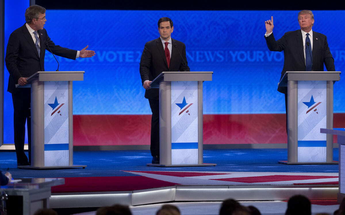 2016 Republican presidential candidates Donald Trump, president and chief executive of Trump Organization Inc., right, and Jeb Bush, former Governor of Florida, left, speaks as Senator Marco Rubio, a Republican from Florida and 2016 presidential candidate, listens during the Republican presidential candidate debate sponsored by ABC News and the Independent Journal Review at Saint Anselm College in Manchester, New Hampshire, U.S., on Saturday, Feb. 6, 2016.