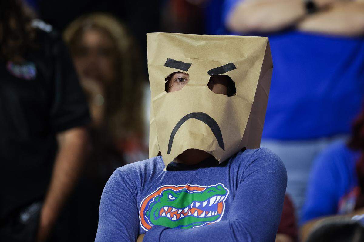 GAINESVILLE, FLORIDA - NOVEMBER 22: A Florida Gators fan reacts by wearing a grocery bag over their head during the second half of the game against the Tennessee Volunteers at Ben Hill Griffin Stadium on November 22, 2025 in Gainesville, Florida. (Photo by James Gilbert/Getty Images)