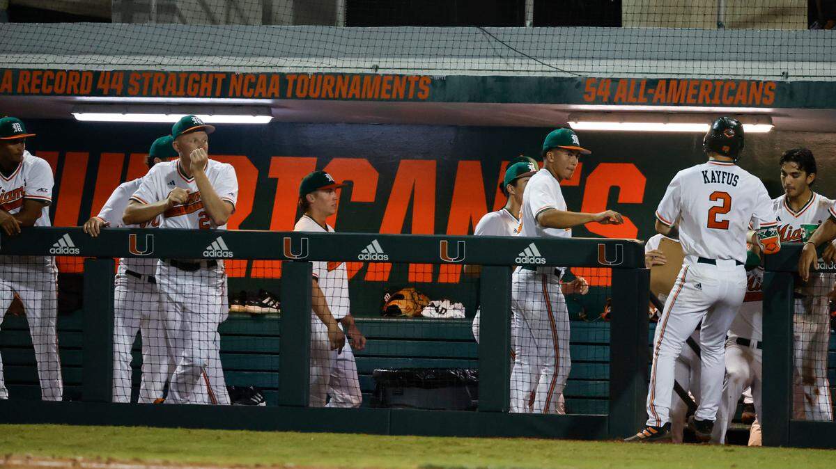 The dugout at Mark Light Field at Alex Rodriguez Park in Coral Gables, Florida on Friday, February 17, 2023. The orange paint reads “NCAA RECORD 44 STRAIGHT NCAA TOURNAMENTS.’’