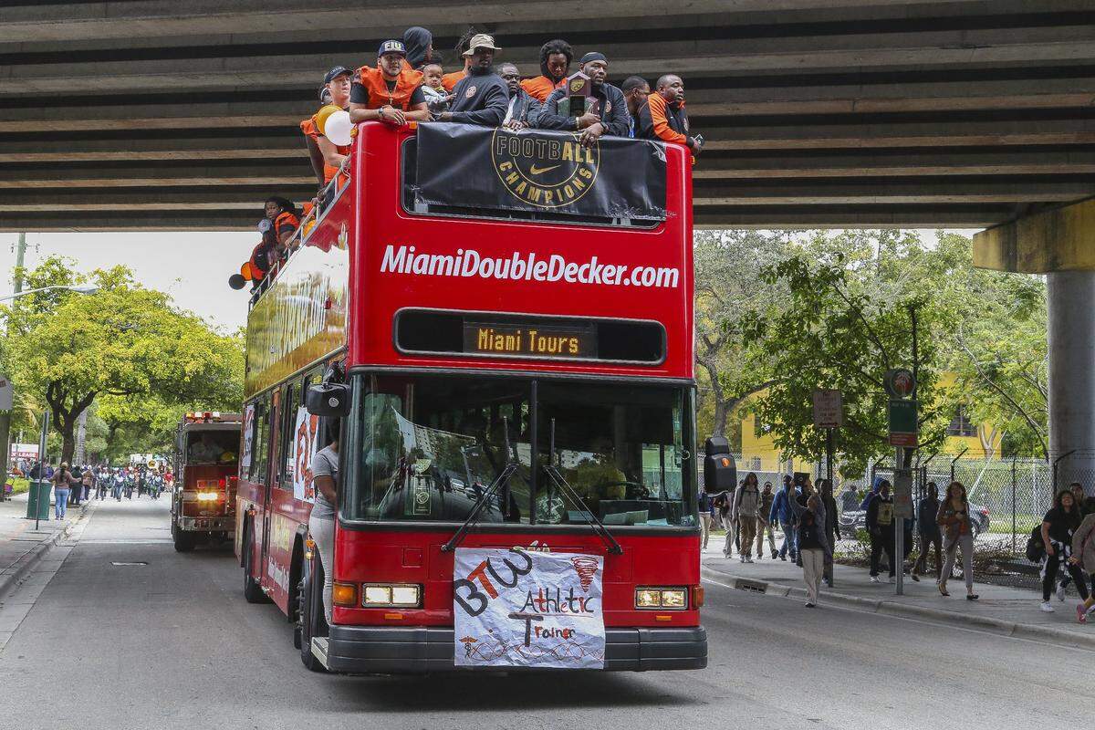 Hundreds of people participate in a victory parade through Overtown for the Tornadoes, Booker T. Washington’s football team, who won the state championship in 2015.