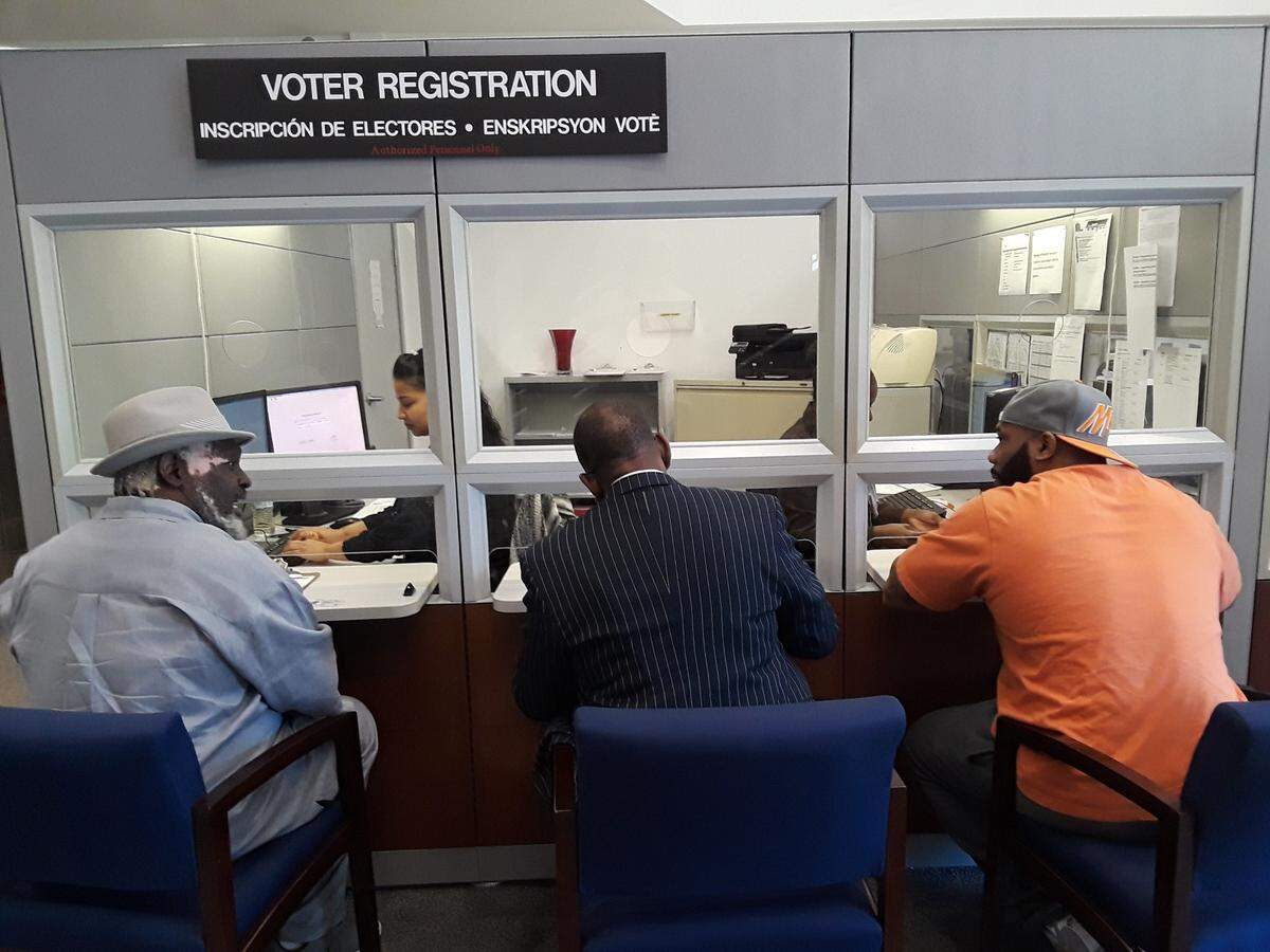 From left: Lorenzo Latson Sr., Clarence Office Jr. and Jerry Armstrong register to vote on Tuesday, Jan. 8, 2019, at the Miami-Dade County Supervisor of Elections Office during the first official day former felons could register in Florida following the passage of Amendment 4.