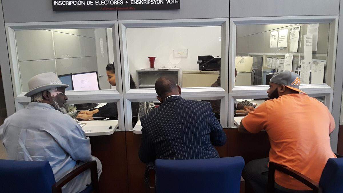 From left: Lorenzo Latson Sr., Clarence Office Jr. and Jerry Armstrong register to vote on Tuesday at the Miami-Dade County Supervisor of Elections Office during the first official day former felons could register in Florida following the passage of Amendment 4.