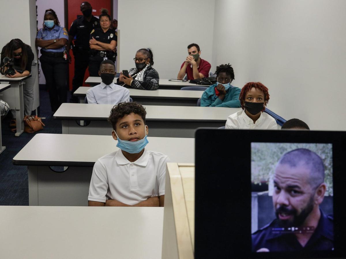 Victor Cochez, 14, watches during Miami Police Officer Nick Perez’s (seen on screen) presentation regarding the dangers of the “Milk Crate Challenge.”