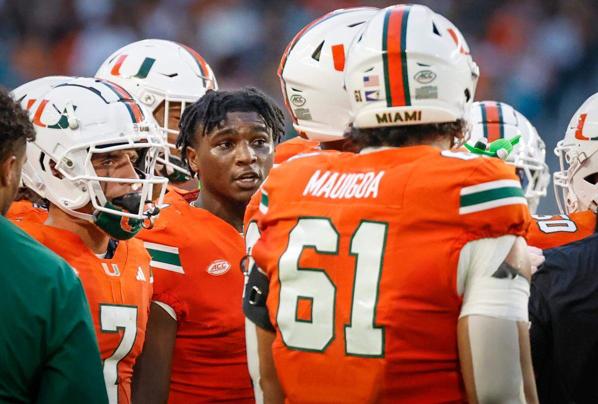 Miami Hurricanes quarterback Cam Ward (1) speaks to teammates during a timeout during the game against the Florida A&M Rattlers in the first half at Hard Rock Stadium in Miami Gardens, Florida, on Saturday, September 7, 2024.