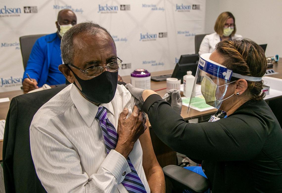Patrick Range, owner of Range Funeral Homes, was among the first five county residents to get the COVID-19 vaccine from RN Susana Flores at Jackson Hospital in Miami on Wednesday, Dec. 30, 2020, as Jackson Health System began vaccinating people 65 and older. The hospital said it plans to vaccinate more than 10,000 people in the coming weeks.