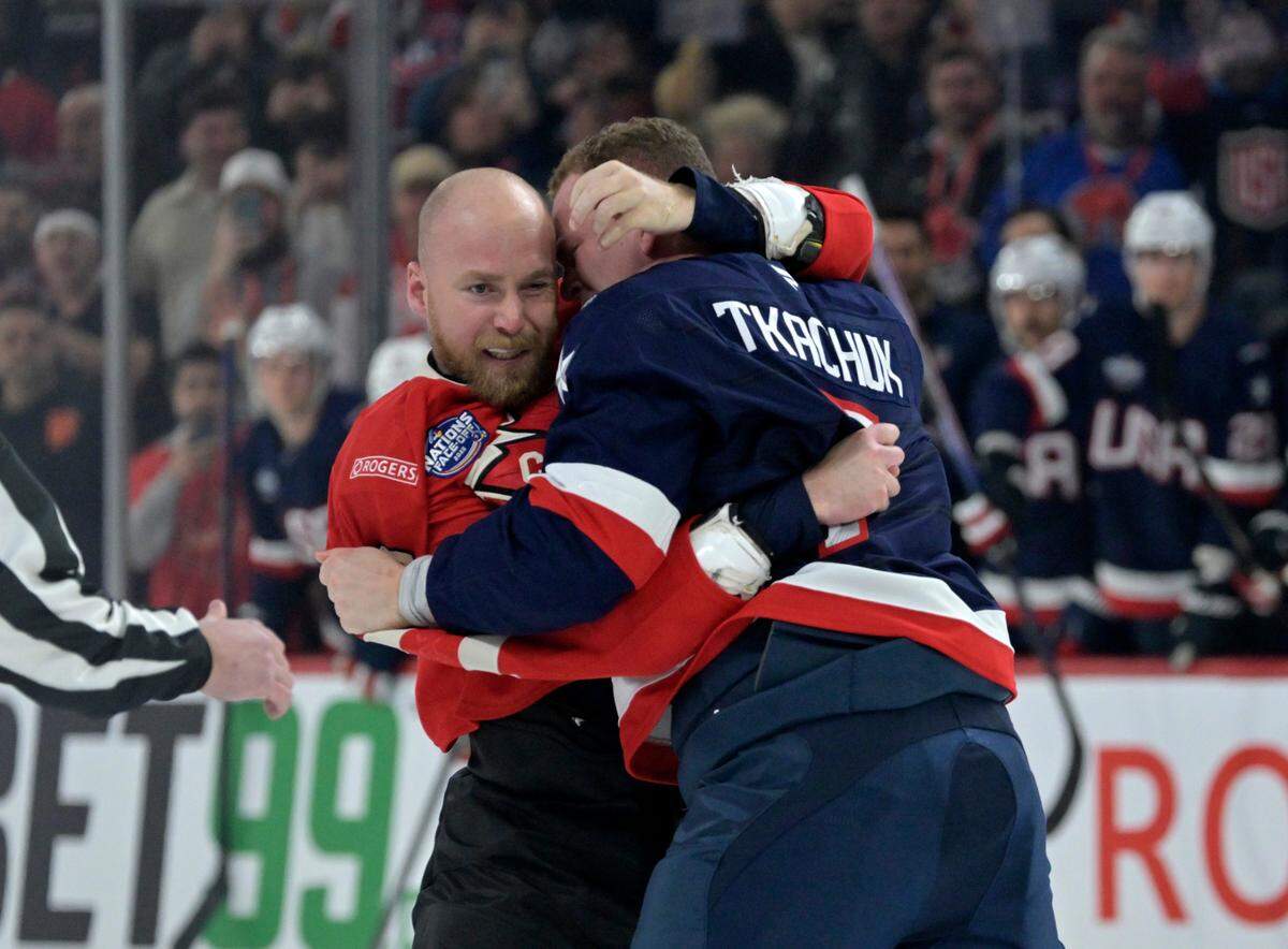 Feb 15, 2025; Montreal, Quebec, CAN; Team Canada forward Sam Bennett (9) and Team United States forward Brady Tkachuk (7) fight in the first period during a 4 Nations Face-Off ice hockey game at the Bell Centre.