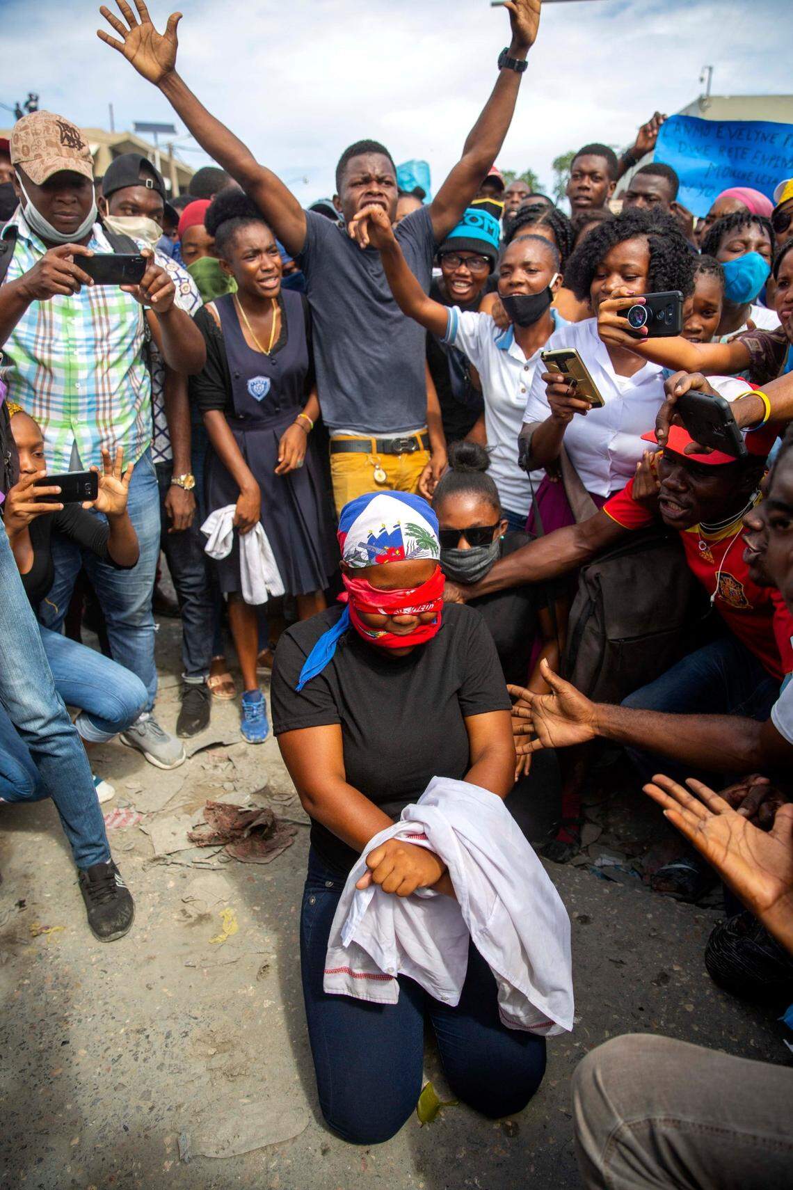 A protester acts out the kidnapping of high school senior Evelyne Sincère in Port-au-Prince, Haiti, Thursday, Nov. 5, 2020. The young woman was found in a trash heap on Nov. 1 after relatives said they were unable to pay the large ransom demanded by her captors. Human rights groups contend the incident highlights the nation’s worsening security crisis.