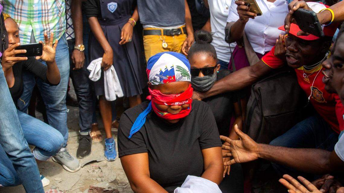 A protester acts out the kidnapping of high school senior Evelyne Sincère in Port-au-Prince, Haiti, Thursday, Nov. 5, 2020. The young woman was found in a trash heap on Nov. 1 after relatives said they were unable to pay the large ransom demanded by her captors. Human rights groups contend the incident highlights the nation’s worsening security crisis.