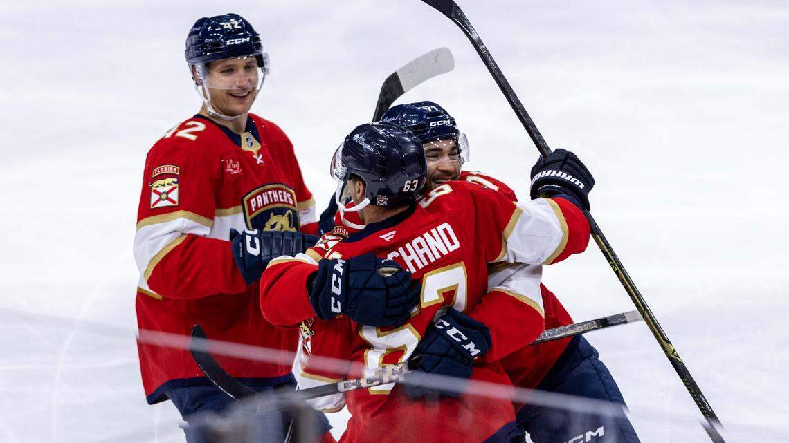 Florida Panthers right wing Mackie Samoskevich (11) and defenseman Gustav Forsling (42) celebrate with left wing Brad Marchand (63) after he scored during the third period of an NHL game at Amerant Bank Arena against the Philadelphia Flyers on Thursday, October 9, 2025, in Sunrise, Fla.